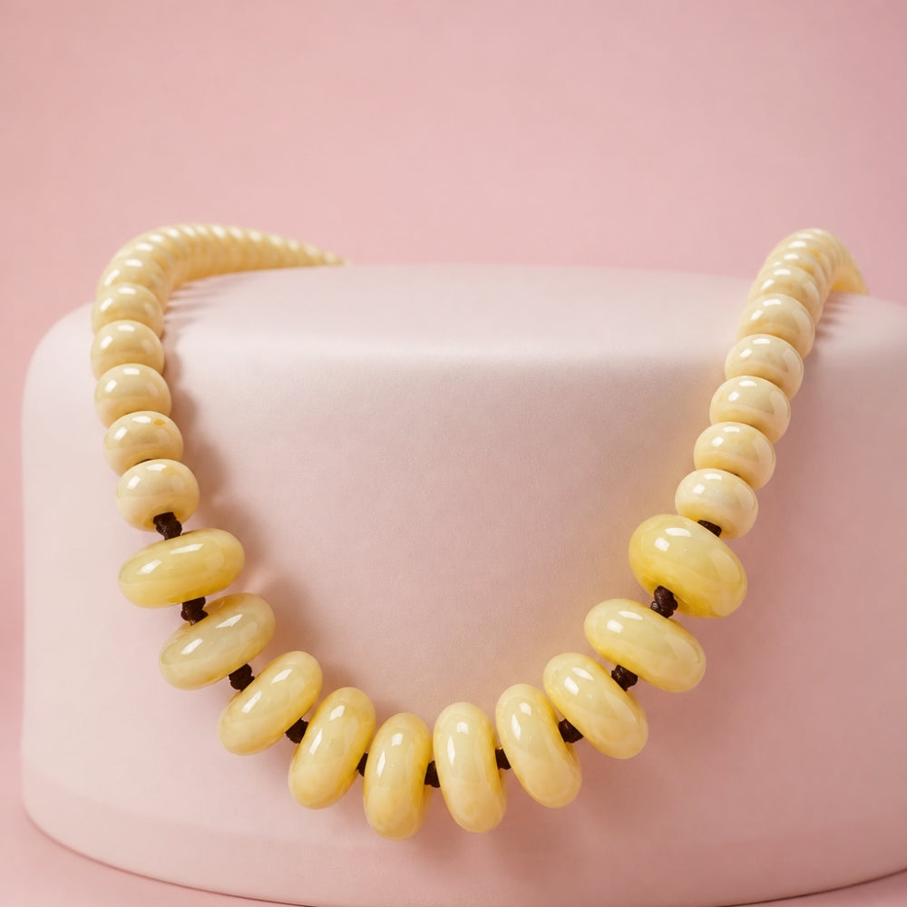 Solene adjustable necklace with high-quality 15 mm and 10 mm ivory acrylic donut beads woven on dark cord